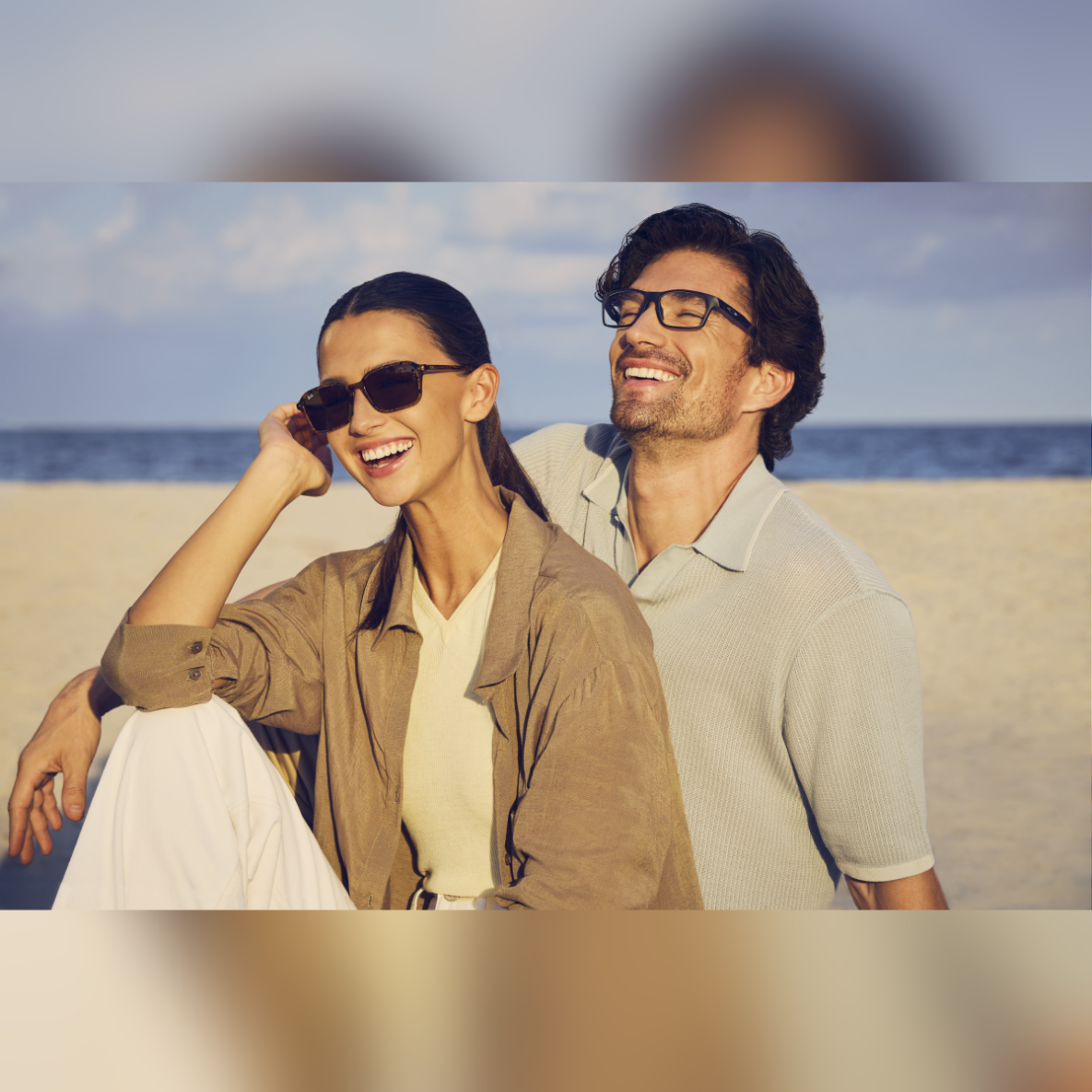 a man and woman wearing OPSM glasses at the beach